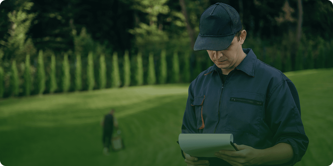 Person taking notes in landscaped yard