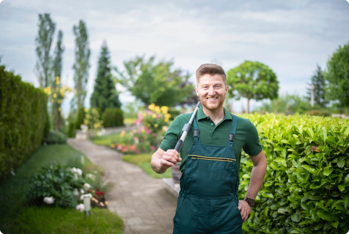Man in overalls holding garden tool
